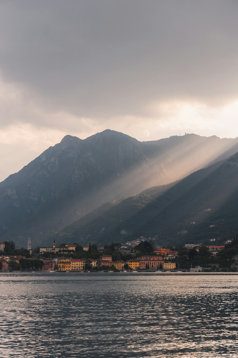 the sun is shining through the clouds over the mountains