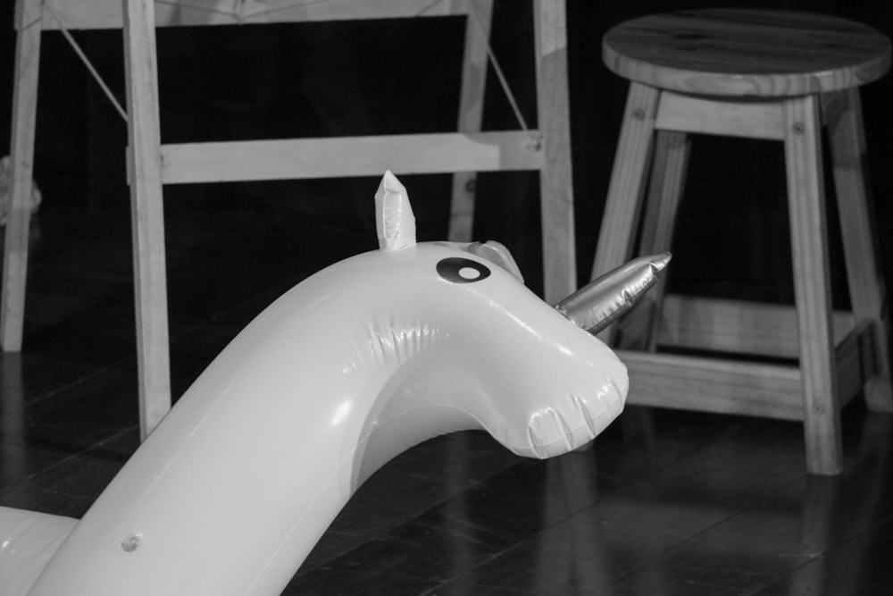 an inflatable unicorn is sitting on the floor