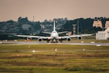 An aerial view of a cargo plane preparing for takeoff on a runway.