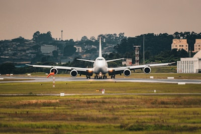 An aerial view of a cargo plane preparing for takeoff on a runway.