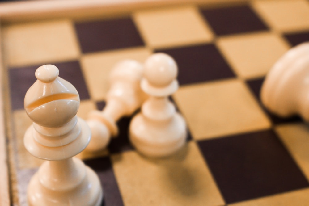 a close up of a chess board with pieces on it