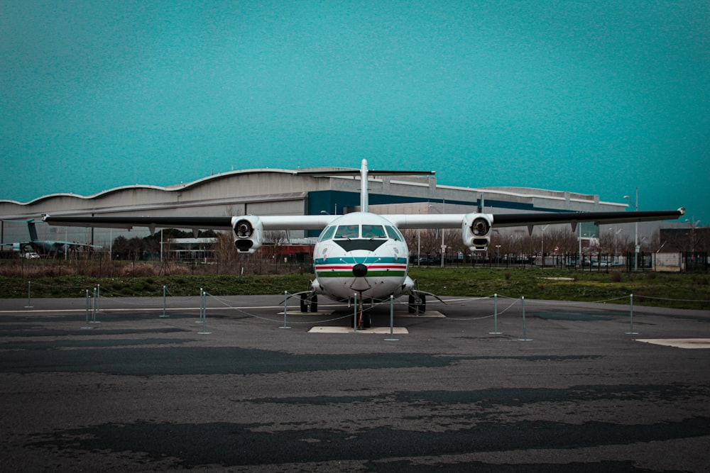 a small airplane parked in front of a building