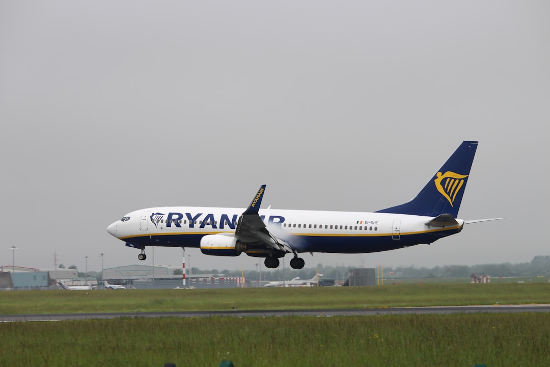 a large jetliner taking off from an airport runway, Ryanair landing in Dublin