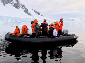 a group of people in an inflatable boat in the water