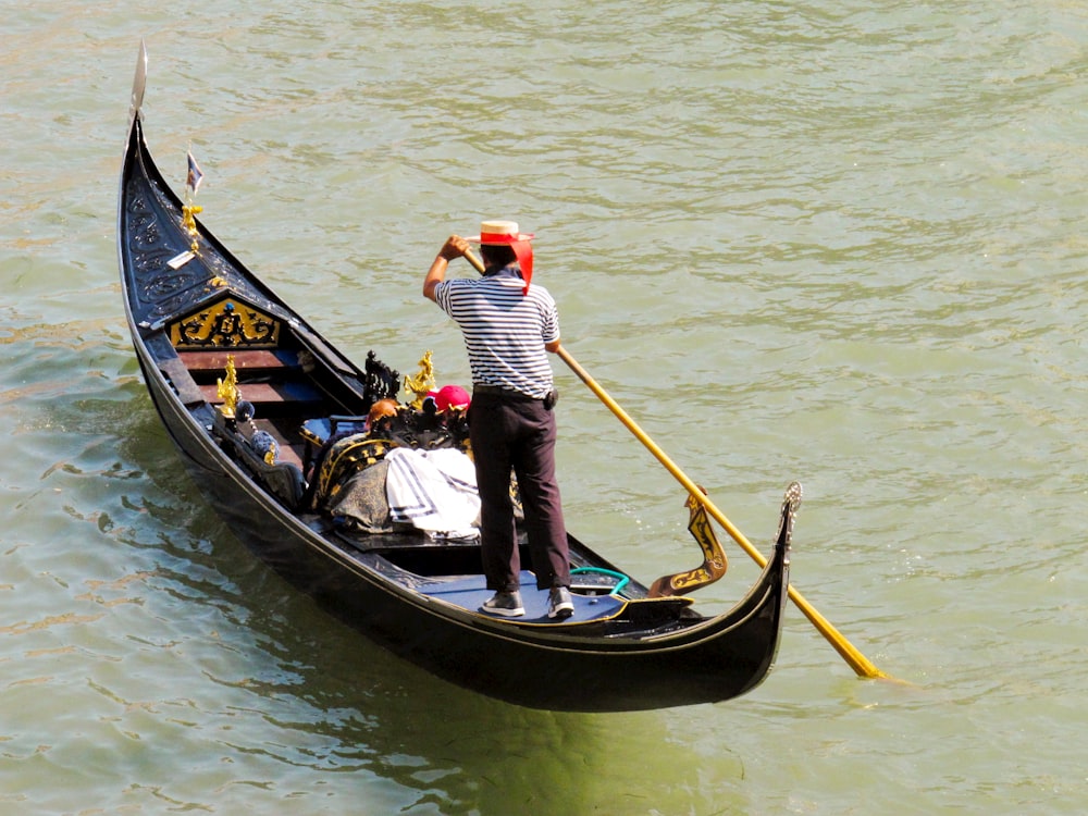 a man standing on a boat in the water