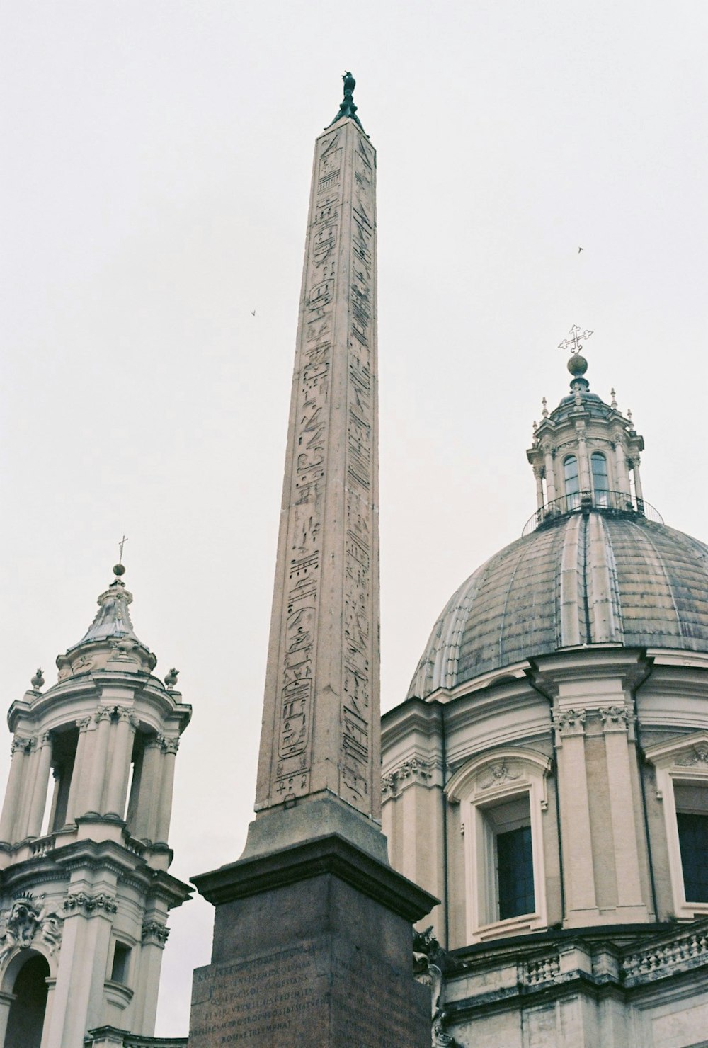 a tall obelisk in front of a building