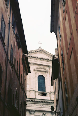 Close-up of a historic church facade nestled among modern city buildings in Philadelphia.