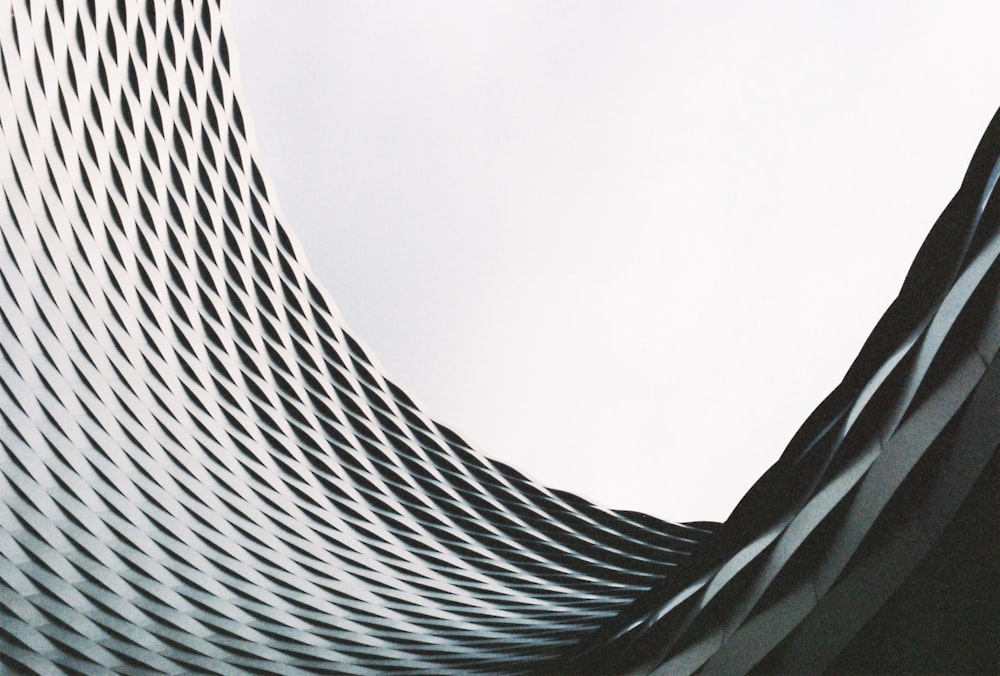 a curved building with a clock on the top of it