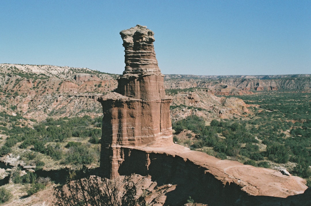 a large rock formation in the middle of a desert, Lighthouse Rock