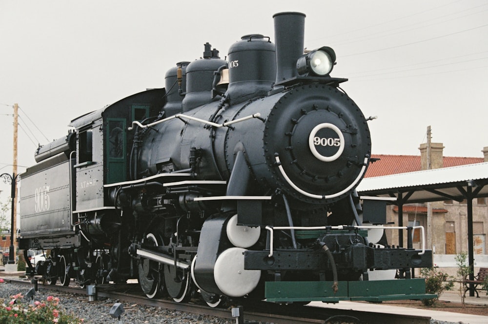 a black train engine sitting on the tracks