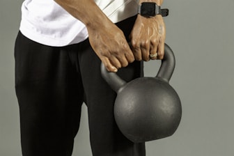a man holding a kettle with both hands
