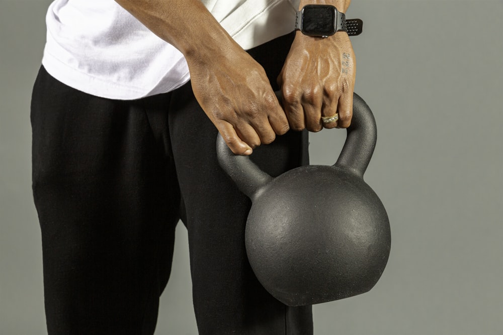 a man holding a kettle with both hands