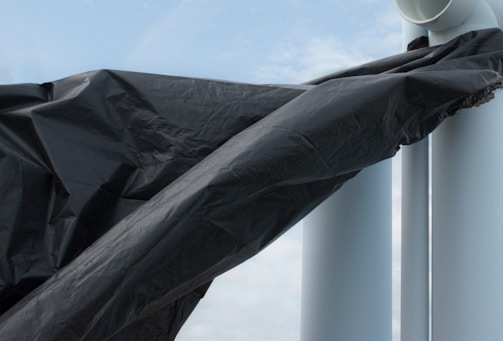 A large warehouse roof fully covered with shrink wrap.