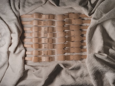 Elegant kitchen utensils arranged neatly on a wooden table.