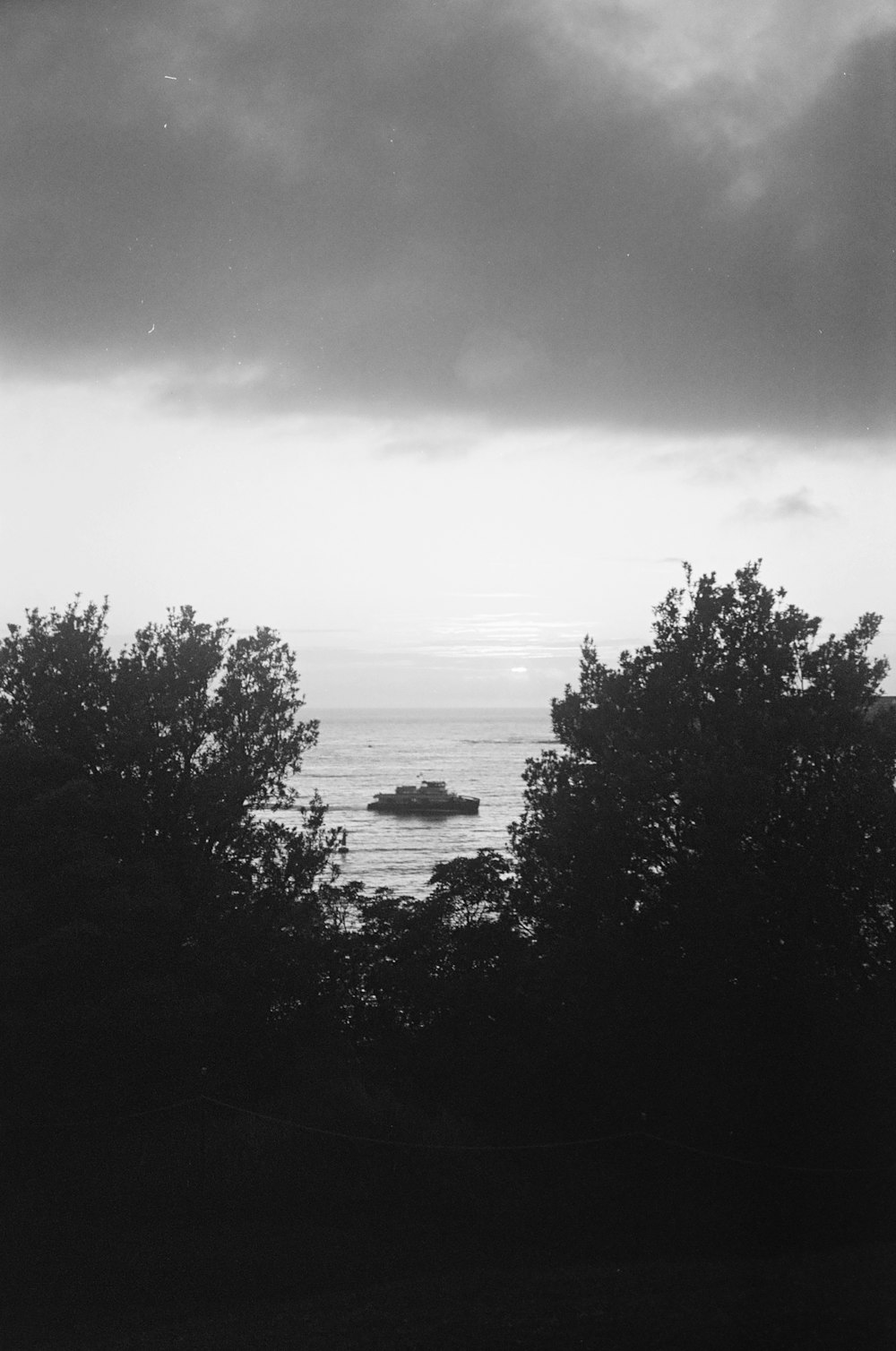 a black and white photo of a boat in the water