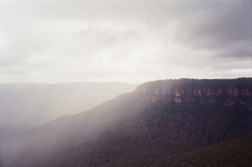 a view of a mountain range with a cloudy sky