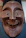 Close-up of a customer holding a finely carved wooden mask, smiling with delight.