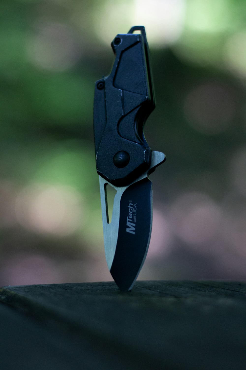 a knife with a black handle on a table