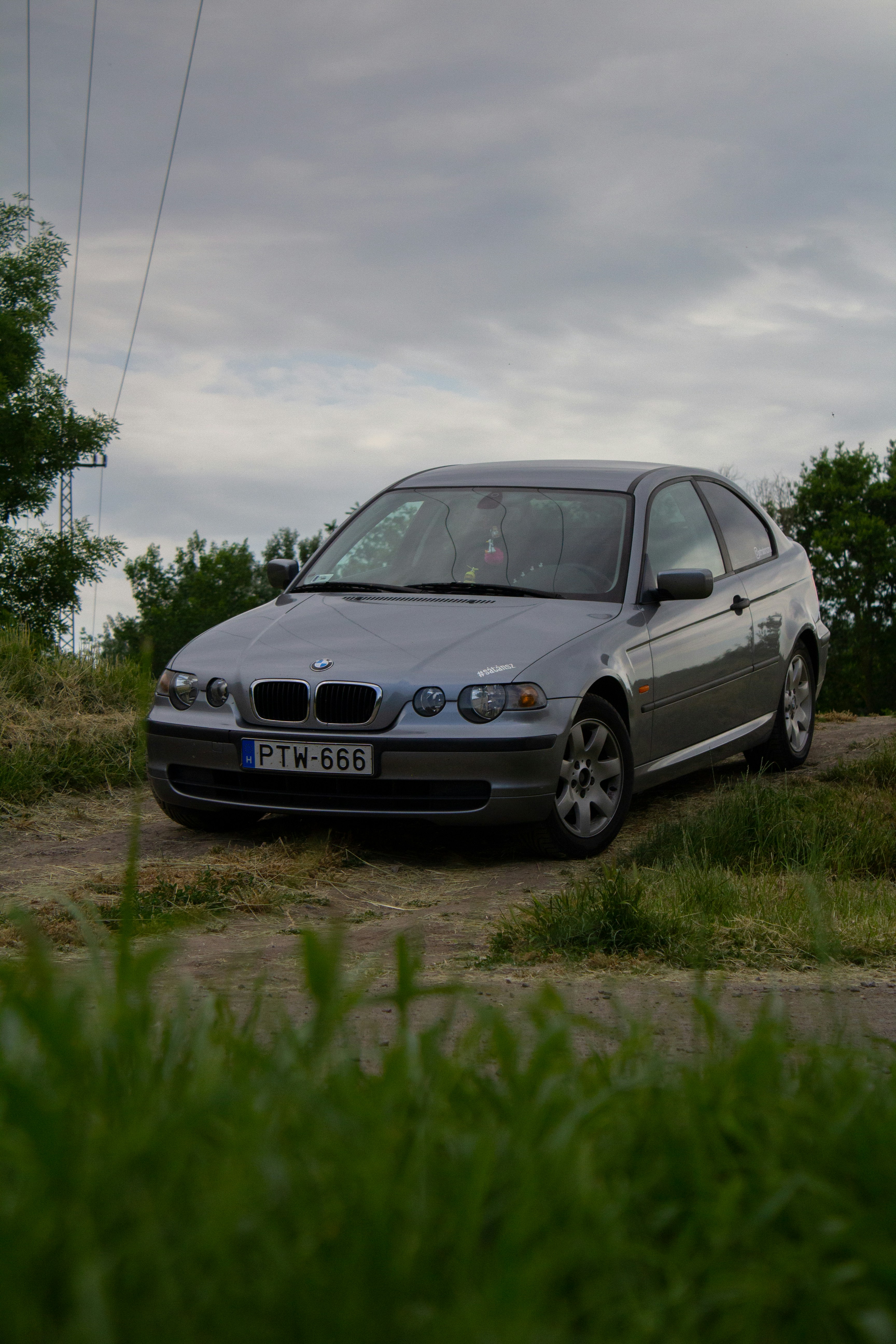 a silver car parked on the side of a road