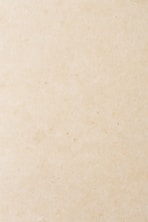 a small bird sitting on top of a piece of paper