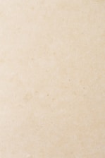 a small bird sitting on top of a piece of paper
