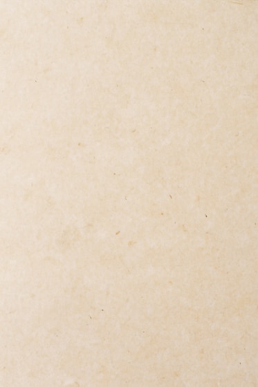 a small bird sitting on top of a piece of paper