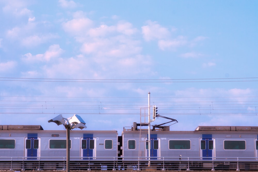 a train traveling down train tracks next to a tall building