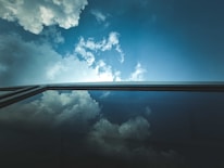 A close-up of sparkling clean windows reflecting a bright blue sky.