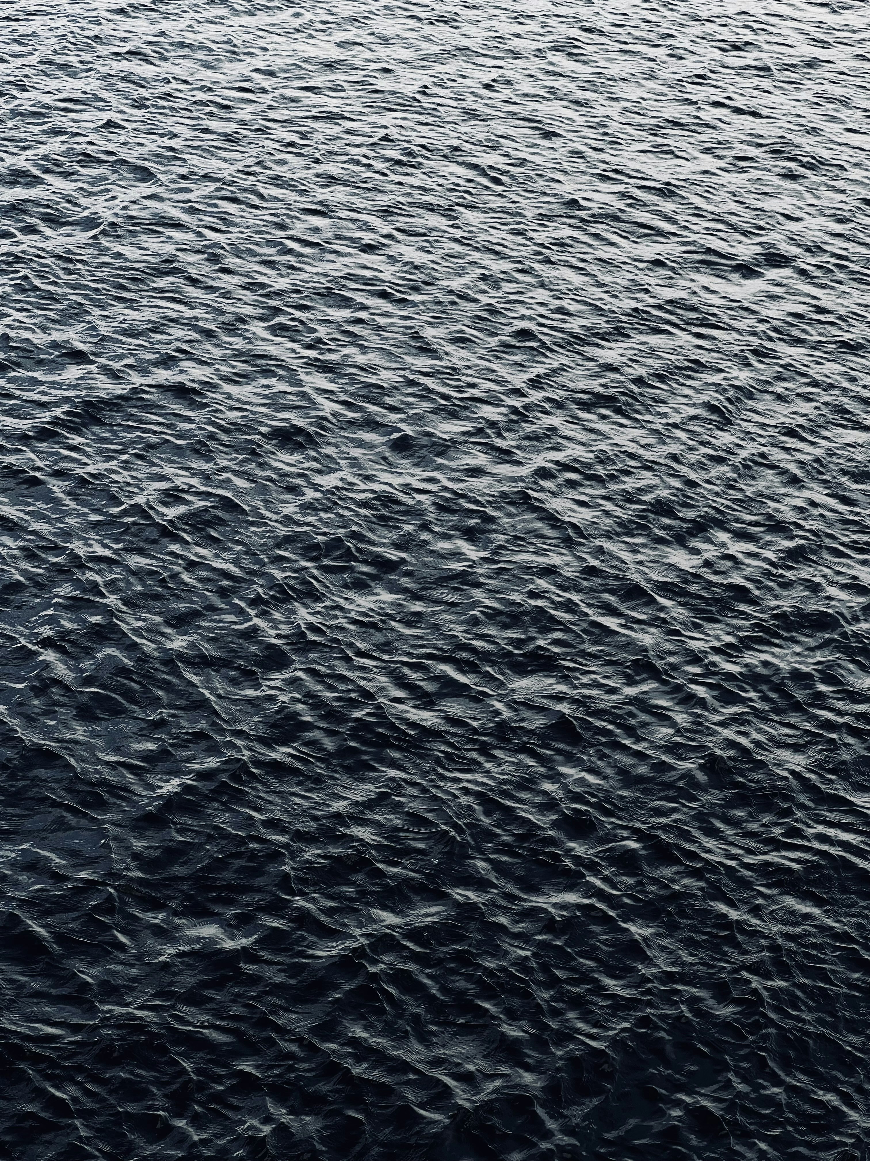 a large body of water with a boat in the distance