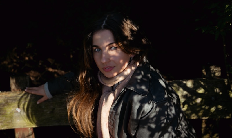 Stylish woman by fence