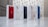 Five iPhone boxes are lined up on a marble surface. Each box showcases a different color of the iPhone, including red, white, black, pink, and blue. The background features a softly blurred light pattern.