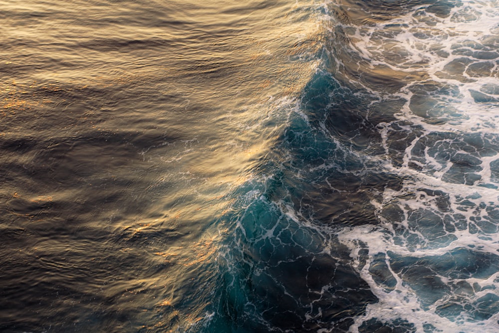an aerial view of the ocean with waves
