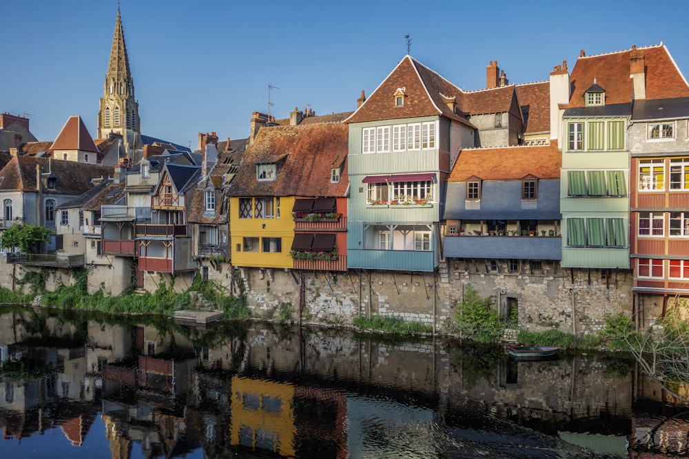 a row of buildings next to a body of water