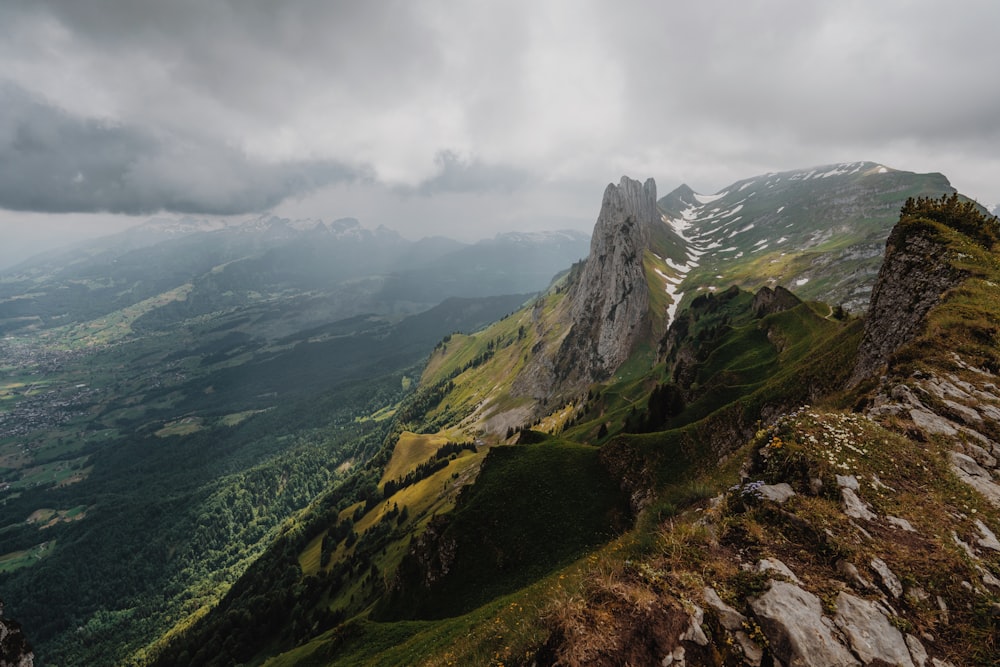 a view of a mountain range from the top of a hill