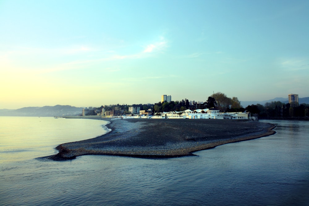 a body of water with a city in the background