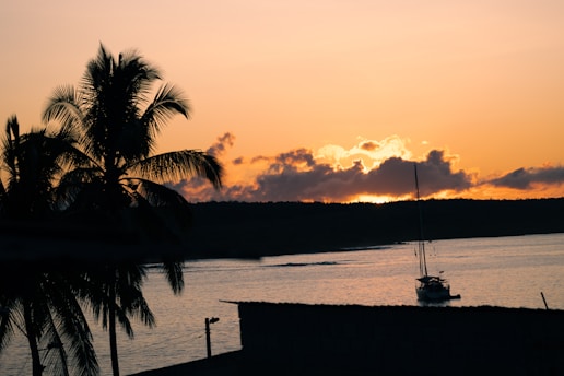 a boat on a body of water at sunset