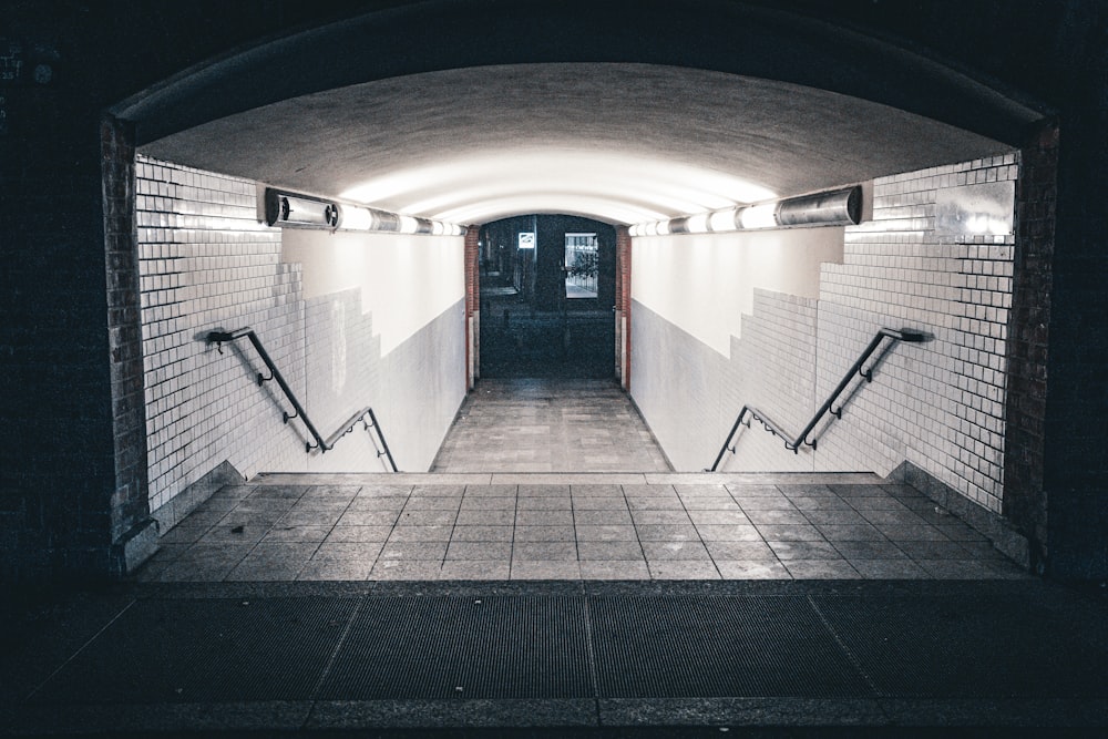 a long hallway with a light at the end of it