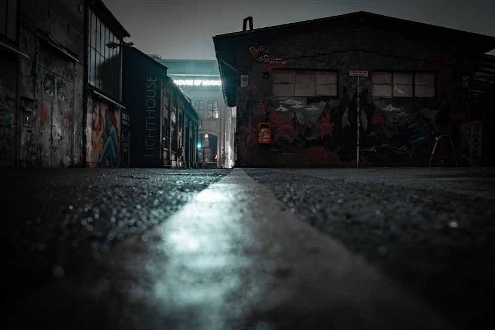 a dark alley way with graffiti on the walls
