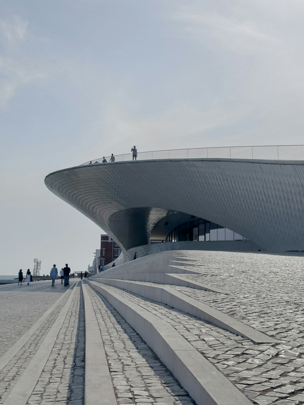 a large building that has a walkway in front of it