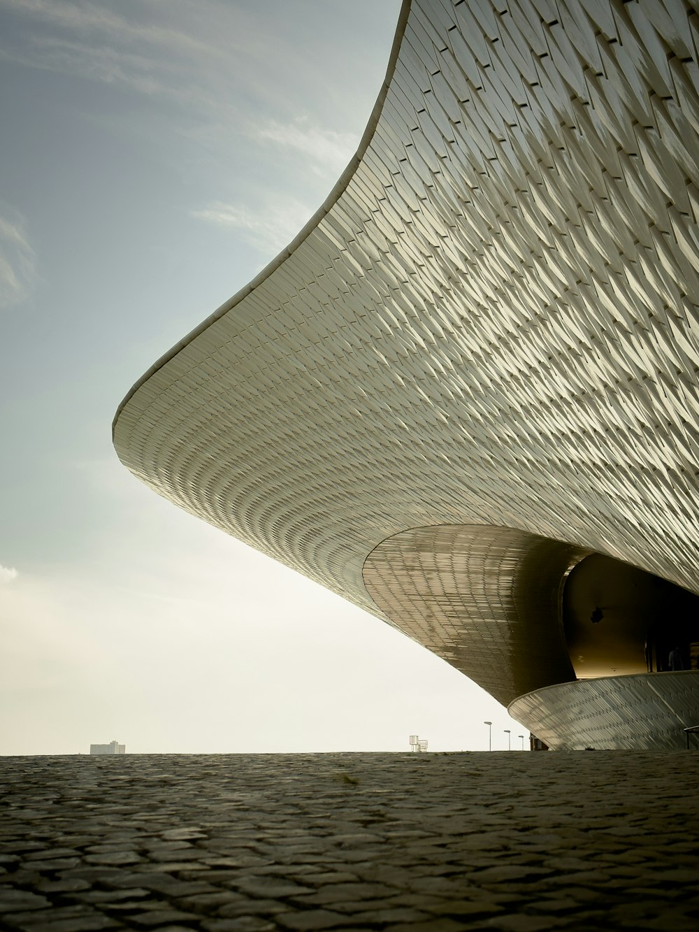 a large building with a curved roof on top of it