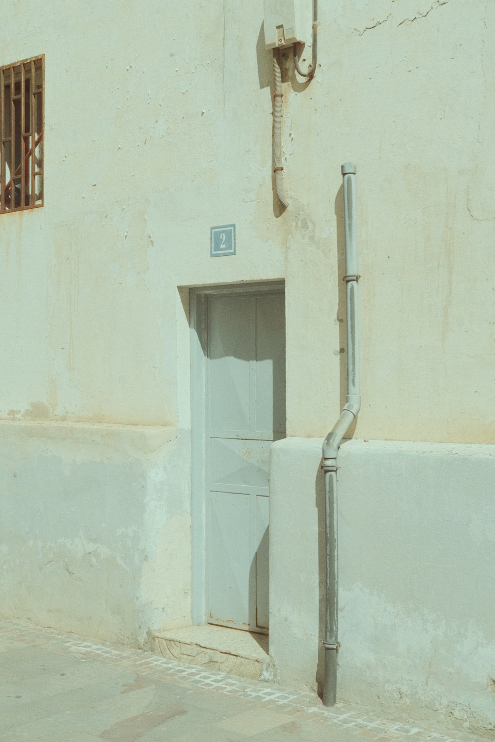 a white building with a door and a window