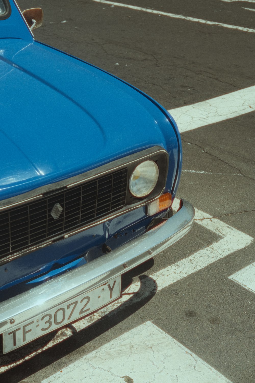 a blue car parked on the side of the road