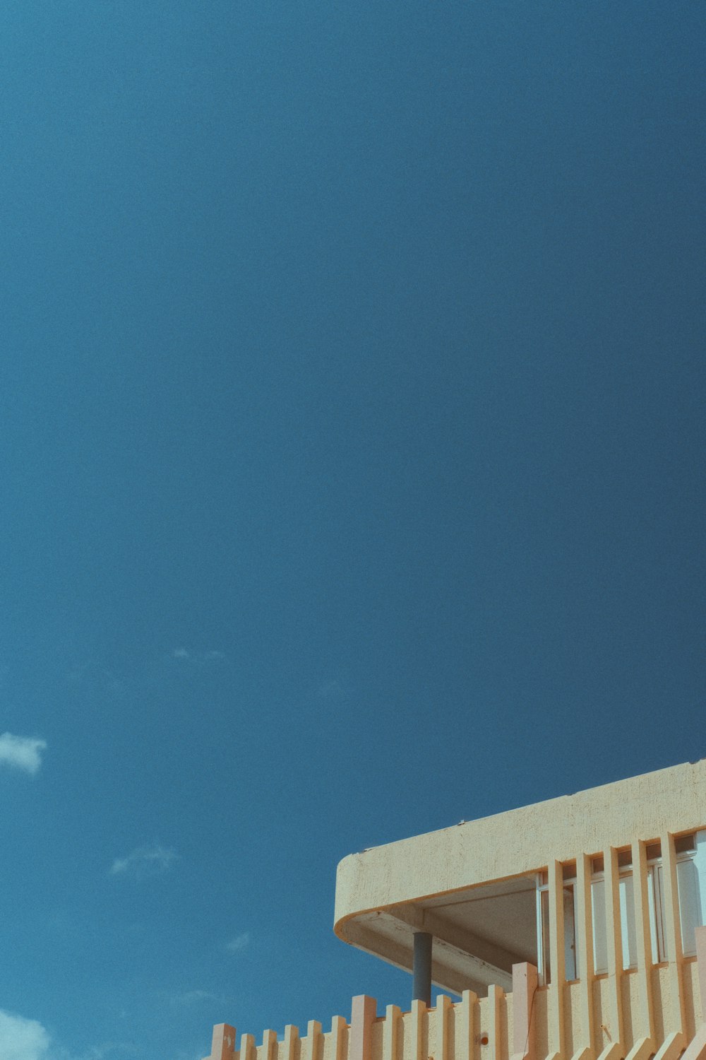 an airplane flying in the sky over a building