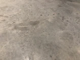 Side-by-side comparison of an industrial floor before and after premium pressure washing.