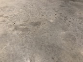 Before and after images of a polished concrete floor in an industrial warehouse.