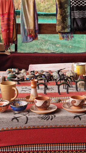 A vibrant display of handcrafted pottery with intricate designs on a rustic wooden table.