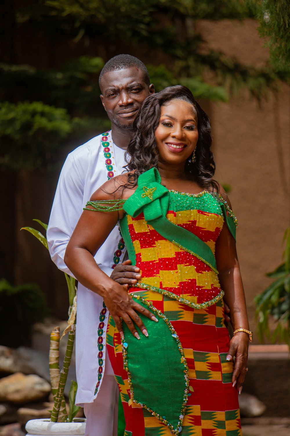 a man and a woman dressed in african clothing