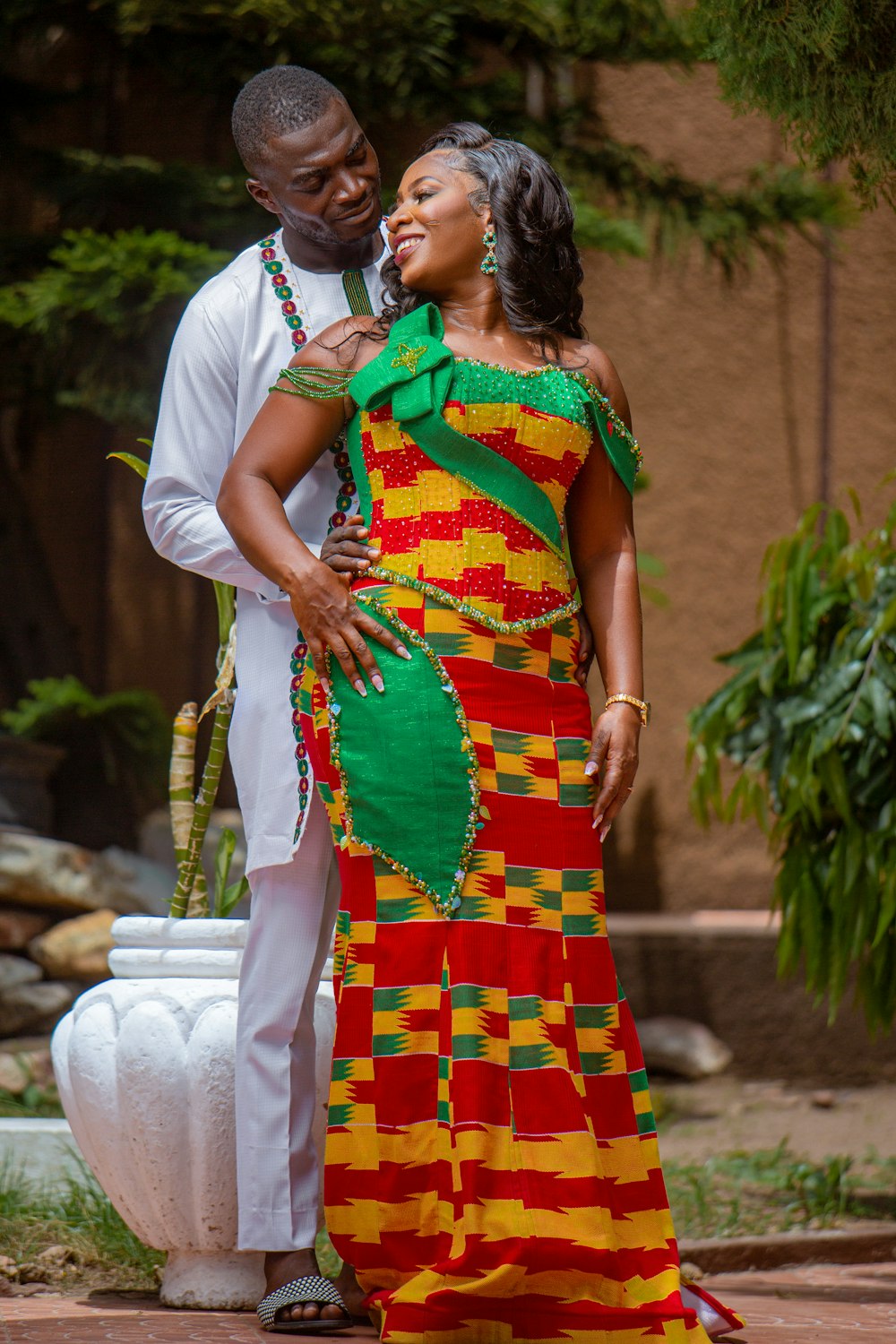 a man and a woman dressed in african clothing