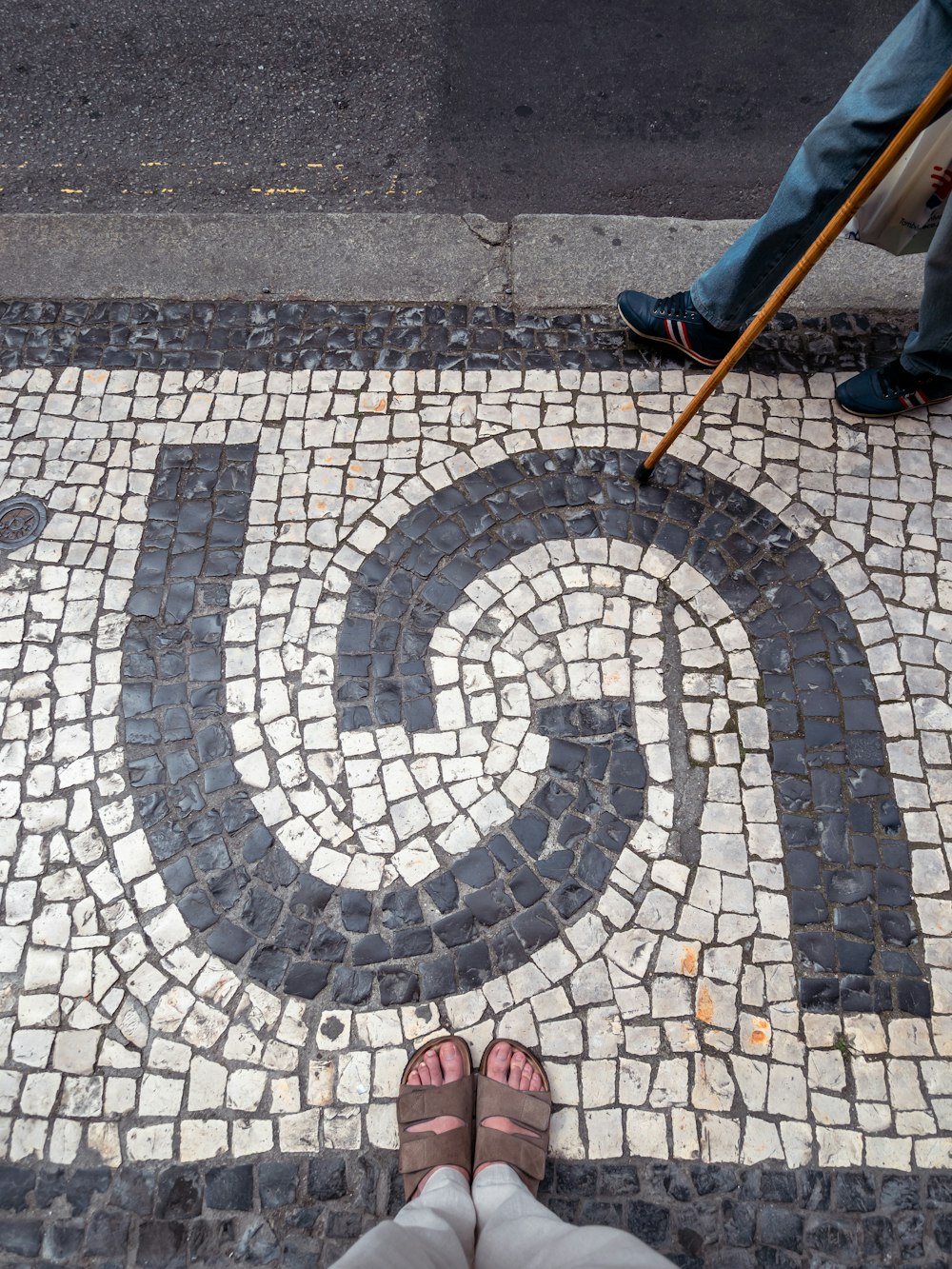 a person standing in front of a sign on a sidewalk