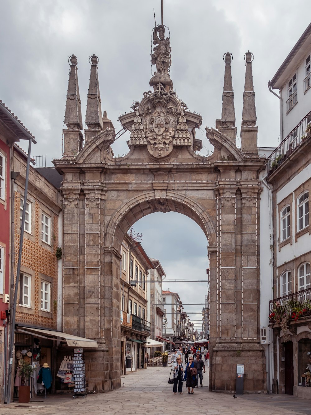 a large stone arch in the middle of a street